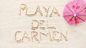Playa Del Carmen sign written in beach sand