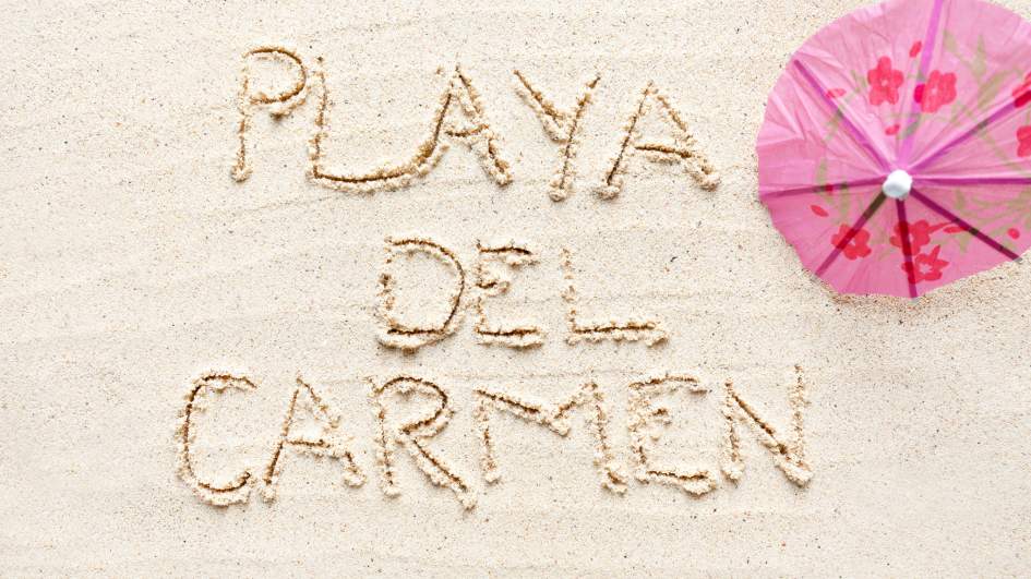 Playa Del Carmen sign written in beach sand